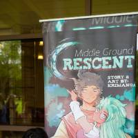 Student writing during Student Small Business Market.